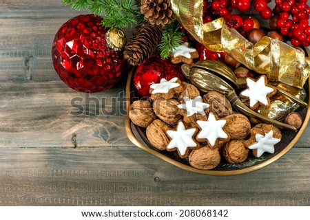 christmas decorations with cinnamon star cookies and walnuts. retro style toned picture