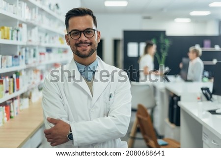 Portrait of a handsome pharmacist working in a pharmacy Royalty-Free Stock Photo #2080688641