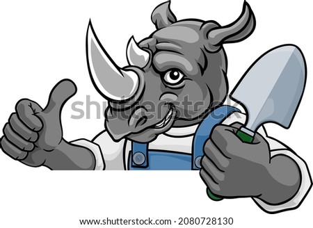 A rhino gardener cartoon gardening animal mascot holding a garden spade tool peeking round a sign and giving a thumbs up