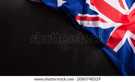 Happy Australia day concept. Australian flag against dark stone background. 26 January.