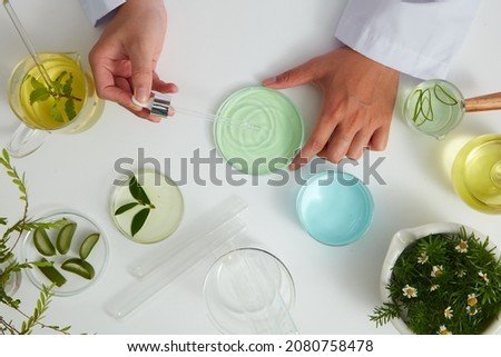Aloe vera extract in petri dish and a white background in laboratory , green leaf  in a test tube and doctor for cosmetic advertising , photography science concept