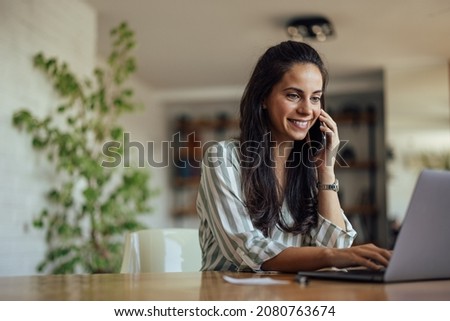 Happy adult woman, coordinating with her team, regarding the project Royalty-Free Stock Photo #2080763674