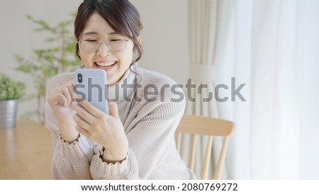 Middle women using smartphones at home.