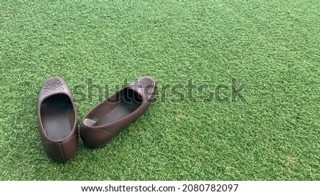 Brown shoes on green grass