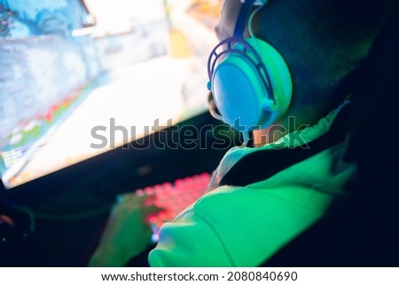 Soft focus, Professional cyber gamer play in video game championship in neon color blur background.