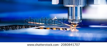 Concept banner background modern industrial technology. CNC Laser engraving cutting of heavy metal with light spark. Royalty-Free Stock Photo #2080841707