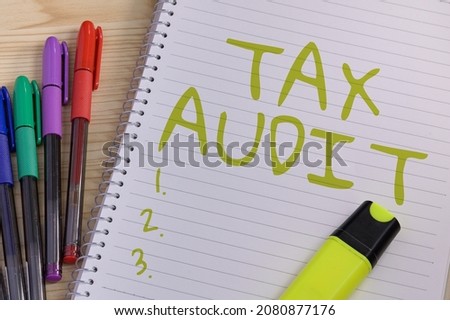 Conceptual caption Tax Audit. Business idea examination or verification of a business or individual tax return Multiple Assorted Collection Office Stationery Photo Placed Over Table