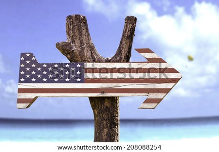 USA wooden sign with a beach on background 