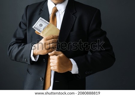 Concept for corruption, finance profit, bail, crime, bribing, fraud, auction bidding Bundle of dollar cash in hand Royalty-Free Stock Photo #2080888819