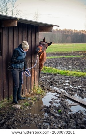 horse and girl afraid of stepping in dirt