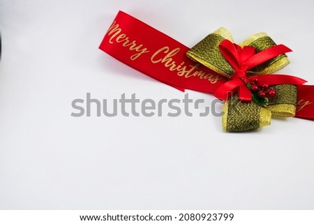 Merry Christmas red ribbon bow. Isolated on white background. Studio shot. Negative space