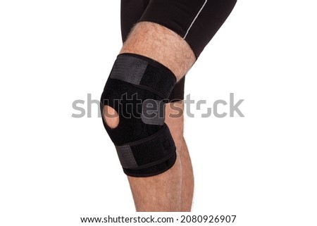 Knee Support Brace on leg isolated on white background. Orthopedic Anatomic. Braces for knee fixation, injuries and pain. Knee Joint Bandage Sleeve. Elastic Sports. Royalty-Free Stock Photo #2080926907