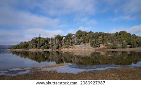 View of the beautiful lake, shore, forest, rocks and mountains perfect reflection in the water surface. Royalty-Free Stock Photo #2080927987