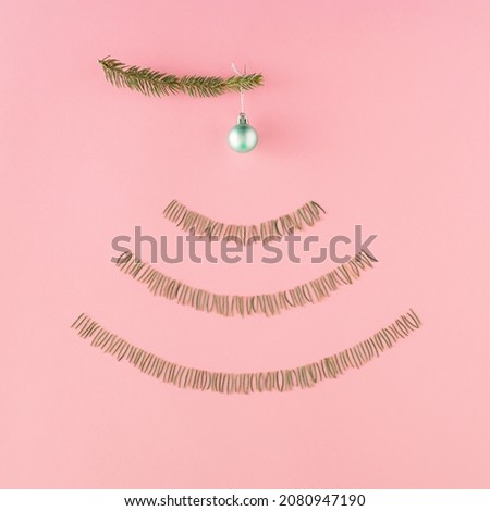Wireless network symbol made of  pine needles shaped into WiFi symbol on a pastel pink background. Minimal internet technology idea. Flat lay winter concept. Christmas and december inspiration.