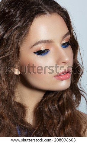 Pensive Woman with Blue Mascara and Holiday Makeup. Visage Royalty-Free Stock Photo #208096603