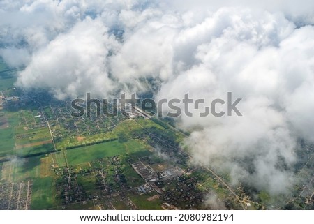 View from the airplane window on takeoff from Boryspil International Airport. Above the clouds, top view. Horizontal aerial photo. Tourism and travel concept. Kyiv (Kiev), Ukraine, Europe.