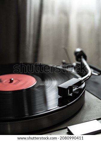 Turntable plays a vinyl record  Royalty-Free Stock Photo #2080990411