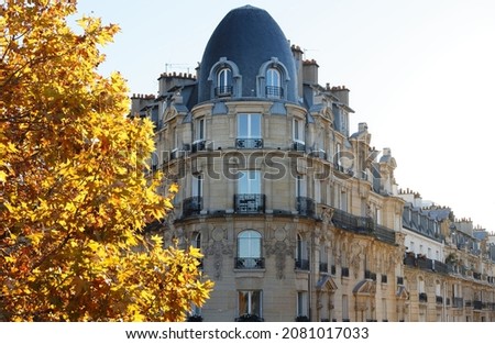 The facade of traditional French house with typical balconies and windows. Paris.