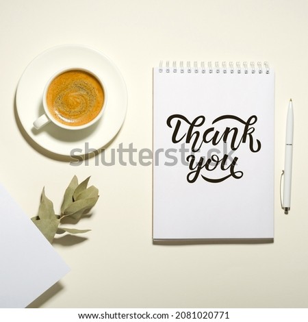 Workplace with a cup of coffee, notebook, pen and dried flowers. Thank you lettering Royalty-Free Stock Photo #2081020771