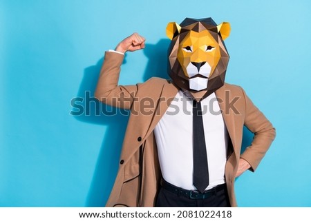 Photo of freak guy wear lion mask demonstrate strong biceps festive mardi-gras event character isolated over blue color background