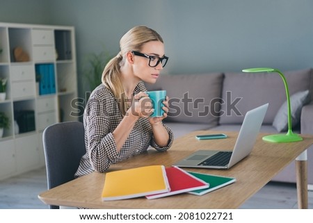 Photo of focused manager accountant economist lady sit desk read netbook economy strategy start up website in modern workspace