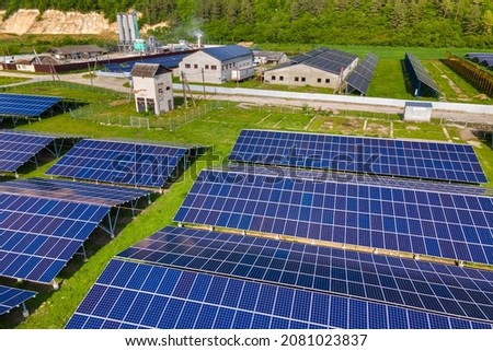 Aerial view of electrical power plant with rows of solar photovoltaic panels for producing clean ecological electric energy at industrial area. Renewable electricity with zero emission concept.