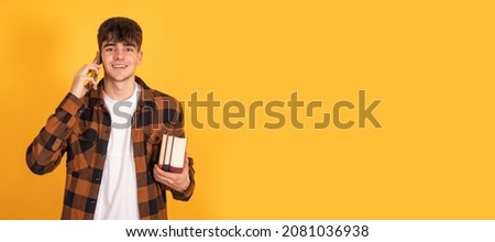 student with mobile phone isolated on yellow background