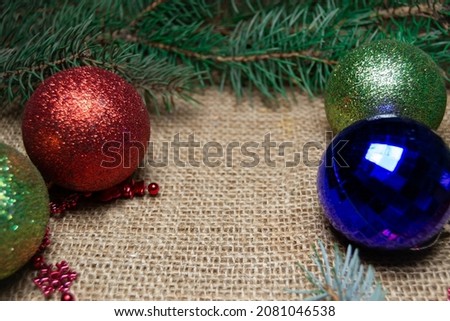 Christmas holidays composition with toys and the coniferous tree branch. Happy New Year and Merry Christmas concept