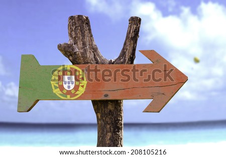 Portugal wooden sign with a beach on background 