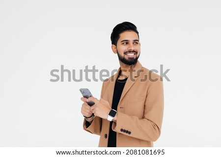 Portrait young businessman using cellphone on white background