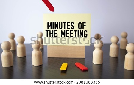 blue board with text MINUTES OF THE MEETING on the office background. Royalty-Free Stock Photo #2081083336