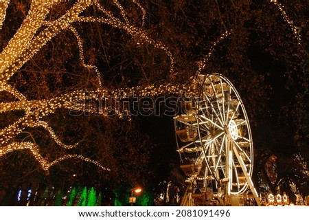 Garland decoration on trees christmas market