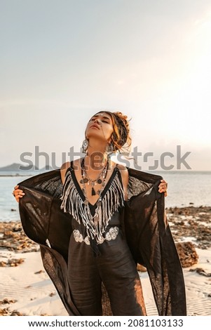 beautiful young stylish woman posing at sunset