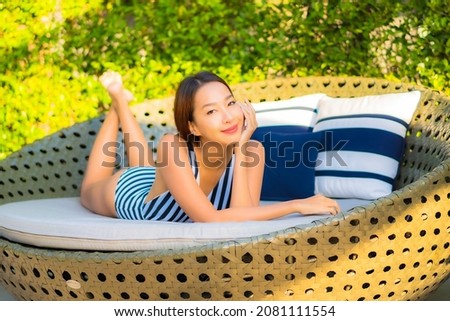 Portrait beautiful young asian woman relax smile leisure on vacation around swimming pool in resort hotel