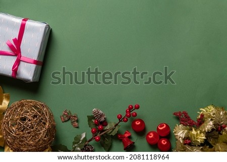 green christmas background with decoration and assorted gifts