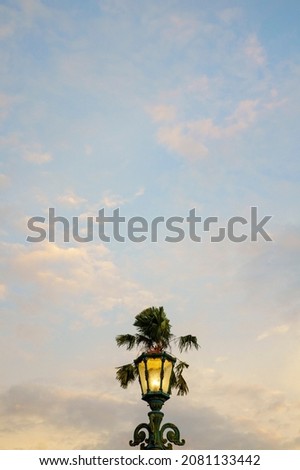 photo of an old street lamp with a clear evening sky