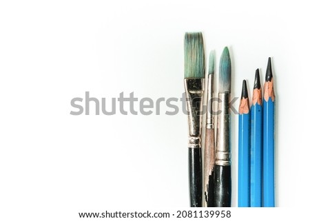 Top view close up or macro frame of different stationery on white background, Brushes painting and  drawing pencils flat lay with space for text or copy space, Back to school concept or art school.