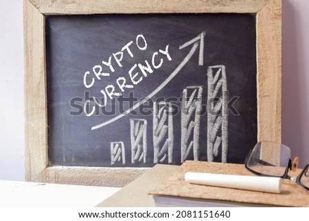 Chalkboard with the text Crypto currency and profit bar chart. The future of digital currency, investment, trading concept. 