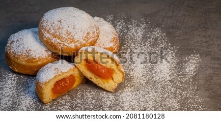 Freshly cooked Apricot jam doughnuts, referred to as jelly doughnuts, donuts in the US Royalty-Free Stock Photo #2081180128