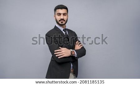 businessman standing with folded hand in black suit indian pakistani model Royalty-Free Stock Photo #2081185135