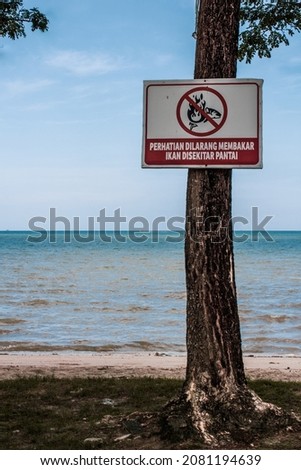 A sign prohibiting burning fish on the sand along Nambo Beach, Southeast Sulawesi.