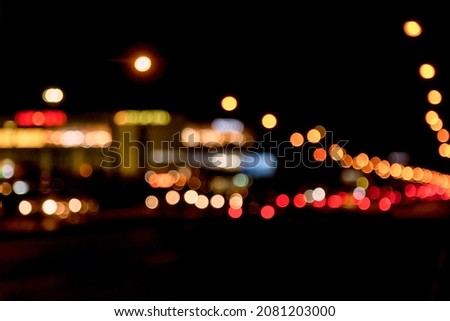Abstract bokeh background of night street with car and street lamps. City life, defocused lights from cityscape, style color tone. Concept of abstract stylish urban backgrounds for design. Copy space
