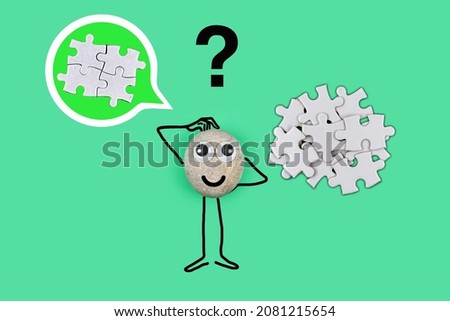 Animated character from a pebble with a happy face thinking how assemble the components into a finished product in his mind