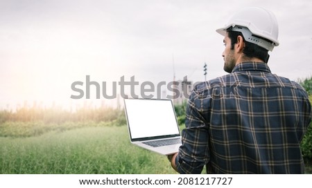 Handsome business engineering using laptop for searching location to build an airport in the center of a big city. Concept of air transport and global export transportation. White screen for design