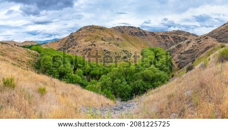 Valley of Ida Burn river at Central Otago Railway bicycle trail in New Zealand
