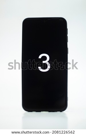 Black smartphone with picture number 3 on white background