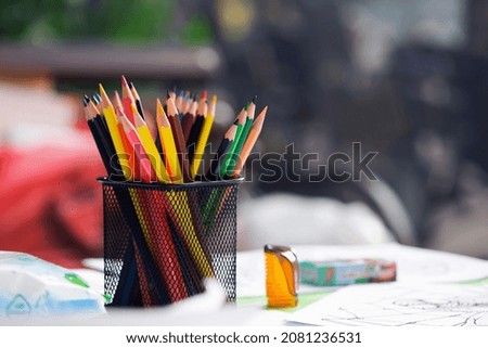 multicolored pencils in the office. Drawer for pens and pencils. Colored pencils in a pencil case. Colored pencils in black isolated case. concepts for concessions, school and office supplies Royalty-Free Stock Photo #2081236531