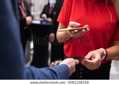 Event QR code ticket scanning before begining of business conference Royalty-Free Stock Photo #2081238358