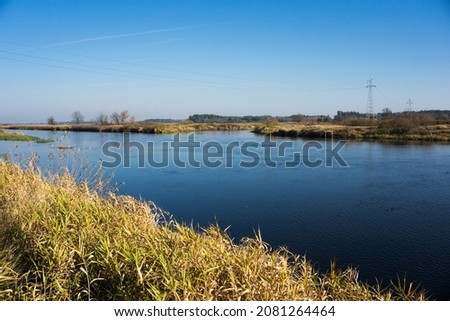 Autumn river landscape. Water flow background. Countryside winter scenic view.