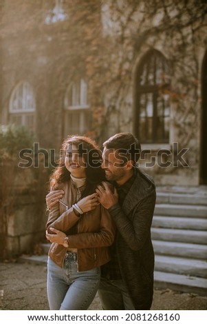 Handsome young couple walking in autumn park